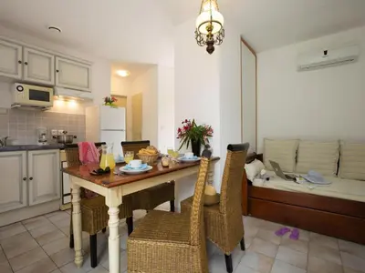 a kitchen and living room with a table and chairs at Apartment in Corsica near Sandy Beach in Favone