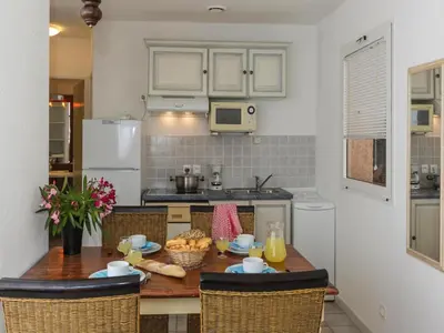 a kitchen with a wooden table with food on it at Apartment in Corsica near Sandy Beach in Favone