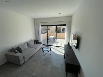 a living room with a couch and a table at CLOS ARIA NOVA in Lucciana