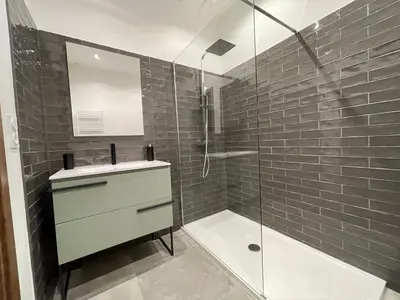a bathroom with a sink and a glass shower at CLOS ARIA NOVA in Lucciana