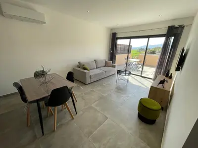 a living room with a couch and a table at CLOS ARIA NOVA in Lucciana