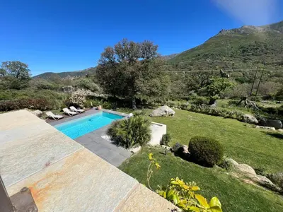 a swimming pool in a yard with a hill at Villa Récente avec Piscine proche L'ILE ROUSSE in Ville-di-Paraso