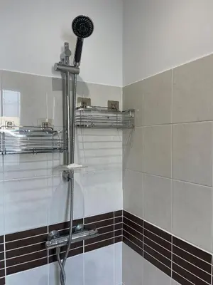 a shower with a shower head in a bathroom at Charmant T2 refait à neuf in Ajaccio
