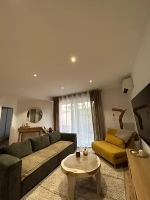 a living room with a couch and a table at Charmant T2 refait à neuf in Ajaccio