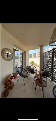 a living room with three chairs and a table at Charmant T2 refait à neuf in Ajaccio