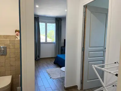 a bathroom with a door leading to a bedroom at Casa Rosalinda in Figari