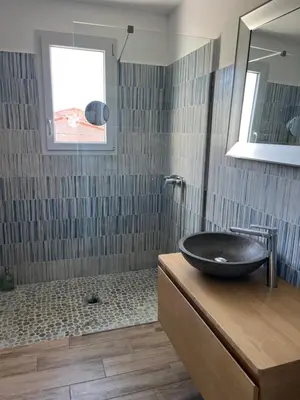 a bathroom with a black sink and a shower at Casa Rosalinda in Figari