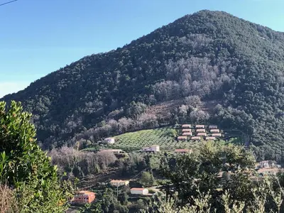 a mountain with houses on the bottom of it at Strada di a cuma in Vico