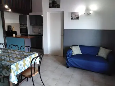 a living room with a blue couch and a table at Strada di a cuma in Vico