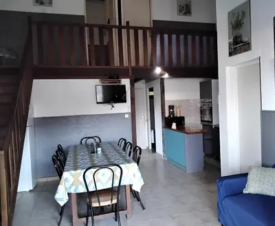 a dining room with a table and chairs and a staircase at Strada di a cuma in Vico
