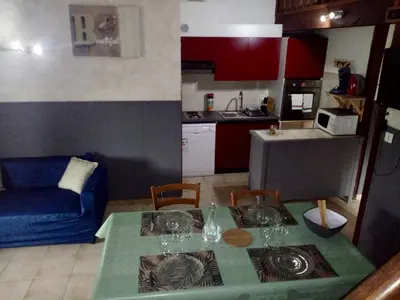 a living room with a table and a kitchen at Strada di a cuma in Vico