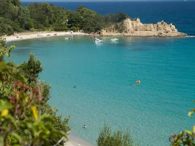 a group of people swimming in the water on a beach at Apartment in Corsica near Canella Beach in Favone