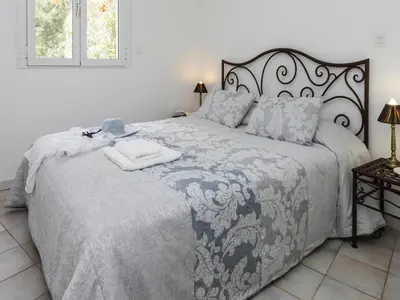 a bedroom with a large bed with a blanket at Apartment in Corsica near Canella Beach in Favone