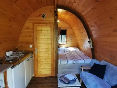 a bedroom in a log cabin with a bed at Ma cabane au fond du jardin in Porto-Vecchio
