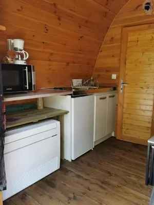 a kitchen with a stove and a microwave at Ma cabane au fond du jardin in Porto-Vecchio