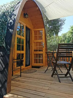 a gazebo with a table and a bench on a deck at Ma cabane au fond du jardin in Porto-Vecchio