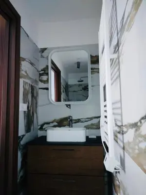 a bathroom with a sink and a mirror at A CASA DI JO in Calenzana