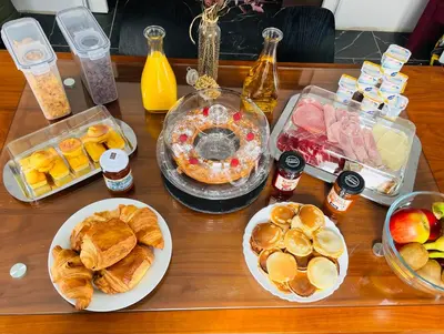 a table topped with plates of pastries and other foods at A CASA DI JO in Calenzana