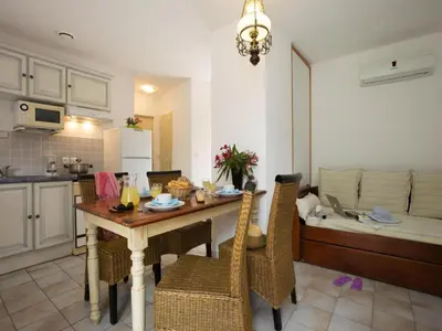 a kitchen and living room with a table and chairs at Res Mare e Monte, Solenzara, Bungalow with terrace in Favone