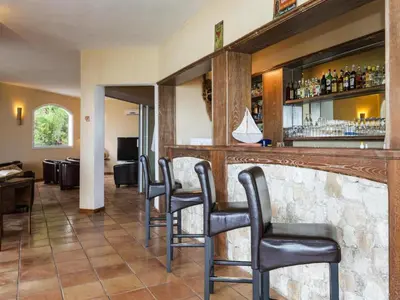 a pool with chairs and people in the water at Res Mare e Monte, Solenzara, Bungalow with terrace in Favone
