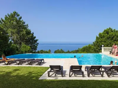a swimming pool with a view of the ocean at Res Mare e Monte, Solenzara, Bungalow with terrace in Favone