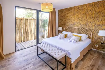 a bedroom with a bed and a balcony at Villa Renajolo 10 pers piscine chauffée 2 min plage en voiture in Sainte-Lucie de Porto-Vecchio