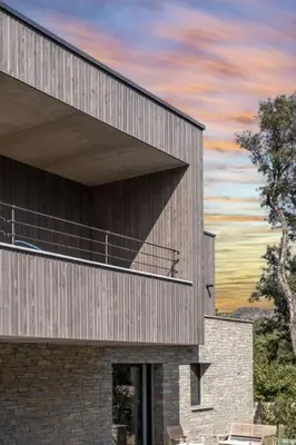 a rendering of a building with a sunset in the background at Villa Renajolo 10 pers piscine chauffée 2 min plage en voiture in Sainte-Lucie de Porto-Vecchio