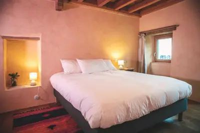 a bedroom with a large white bed with a window at Eco Gîte avec vue sur mer in Chiatra