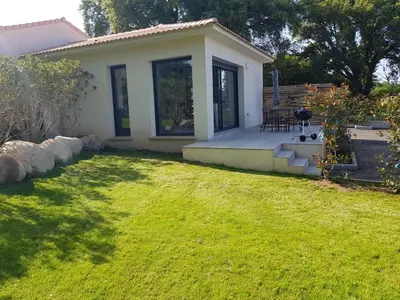 a small house with a green lawn in front of it at Maisons T2 avec jardins privatifs - 10mn de la plage et 5mn du village - Casa di i trinelli in Vescovato