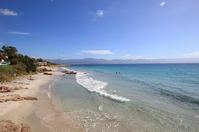 a view of a beach with people in the water at Nice And Bright 60 M With Terrace View On The Sea in Ajaccio