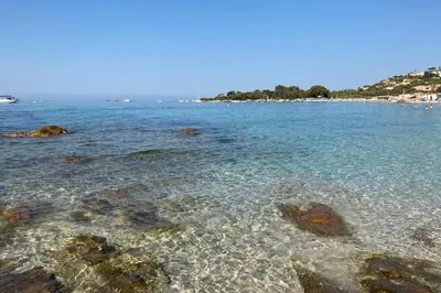a beach with rocks in the water at Nice And Bright 60 M With Terrace View On The Sea in Ajaccio