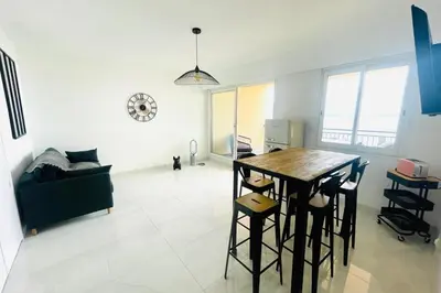 a kitchen and living room with a table and a couch at Nice And Bright 60 M With Terrace View On The Sea in Ajaccio