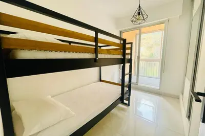 two bunk beds in a room with a window at Nice And Bright 60 M With Terrace View On The Sea in Ajaccio