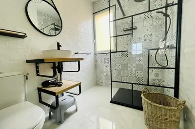 a bathroom with a sink and a toilet and a mirror at Nice And Bright 60 M With Terrace View On The Sea in Ajaccio