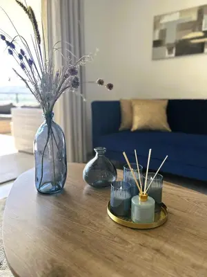 a table with vases and candles on top of it at Sognu di Serena - Superbe appartement avec parking gratuit sur place in Porto-Vecchio