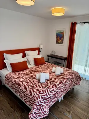 a bedroom with a bed with two towels on it at Villa Arbevhio in Bonifacio