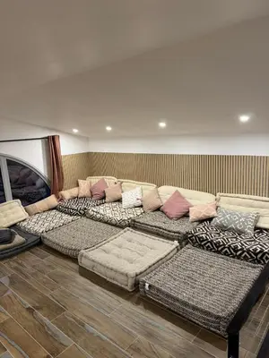a room with a large couch with pillows on it at Villa Arbevhio in Bonifacio