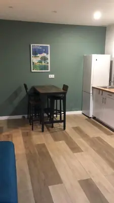 a dining room with a table and a refrigerator at Appart Sylvie B in Porto-Vecchio