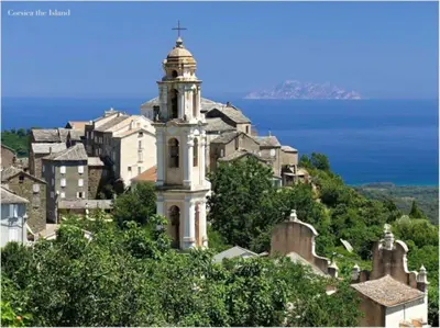 a building with a tower on top of a city at Appartement 1 chambre en Haute-Corse à Pietra Di Verde in Pietra-di-Verde