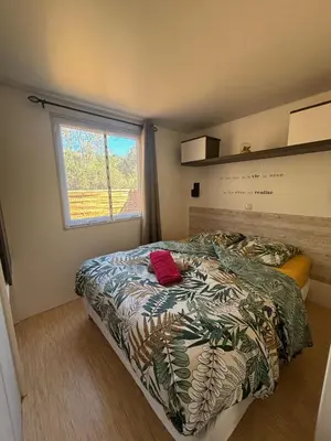 a bedroom with a bed and a window at A Casa Di l'Altana in Porto-Vecchio