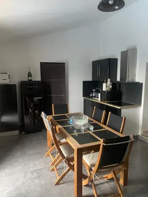 a dining room with a table and chairs in a kitchen at CHAMBRES D'HOTES CENTRE CORSE in Venaco