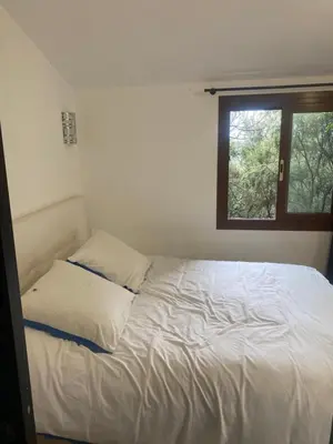 a white bed in a room with a window at CHAMBRES D'HOTES CENTRE CORSE in Venaco