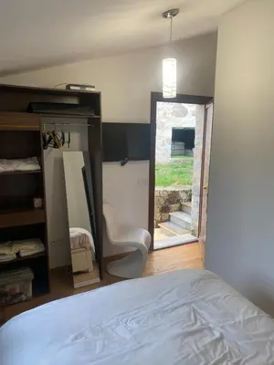a bedroom with a bed and a mirror and a window at CHAMBRES D'HOTES CENTRE CORSE in Venaco