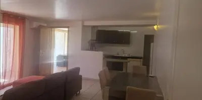 a living room with a dining table and a kitchen at corse in Appietto