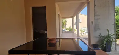 a house with a pool in the middle of a room at corse in Appietto