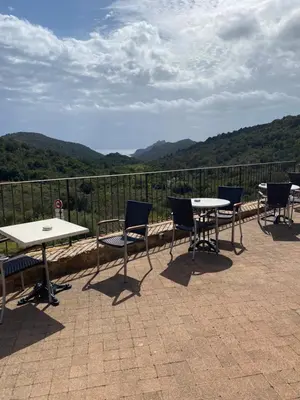 a group of tables and chairs sitting on a patio at Auberge Coralli in Sartène
