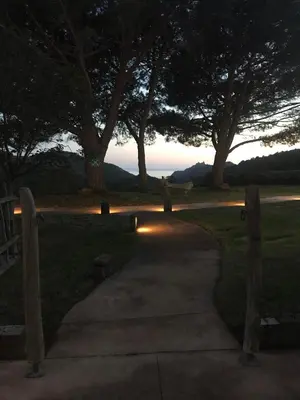 a person walking down a path at sunset at Auberge Coralli in Sartène
