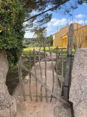 a wooden gate in front of a house at Auberge Coralli in Sartène