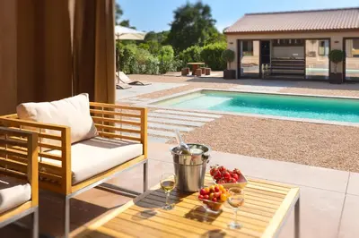 a table with a bowl of fruit and wine glasses at **** VILLA CASA DI FIUMU **** in Porto-Vecchio