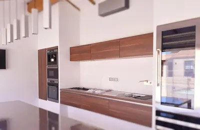 a kitchen with wooden cabinets and a stove at **** VILLA CASA DI FIUMU **** in Porto-Vecchio